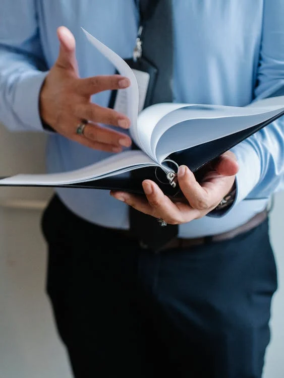 Person holding open binder